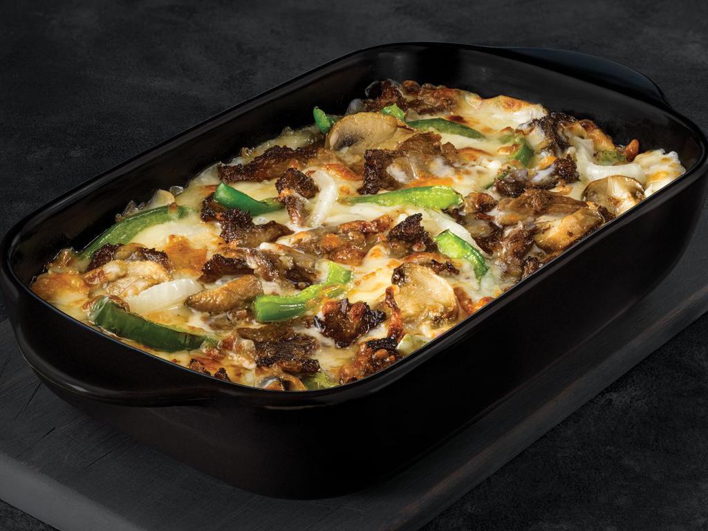 The Philly Bowl · Crustless pizza baked in a bowl. Melty white cheese sauce, tender shaved steak, marinated mushrooms, freshly sliced green peppers and onions and our three fresh signature cheeses