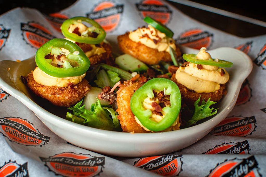 Not Your Mama's Deviled Eggs · Five lightly fried deviled eggs with a spicy filling, crumbled bacon & garnished with a fresh jalapeno slice.