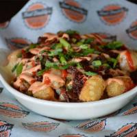 Atomic Tots · Crispy tots topped with our Amber Ale queso, Pepper jack cheese, jalapenos, Sriracha sour cr...