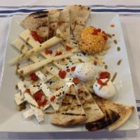 Meraki Cheese Platter · Assortment of feta, Vlahotyri, goat cheese, and Tyrokafteri (spicy feta spread). Served with...