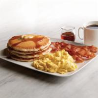 Buttermilk Pancakes with Eggs & Bacon · Four fluffy buttermilk pancakes with butter and vanilla maple syrup. Served with a side of b...