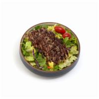 Beef Teriyaki Salad · Large garden salad topped with our famous teriyaki beef.