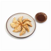 Gyoza · Potstickers : Deep-fried beef & vegetable dumplings served
with our savory soy-ginger sauce.