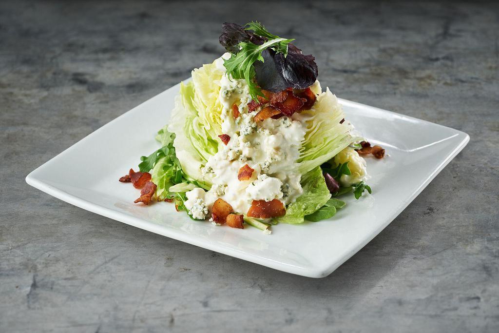 Lettuce Wedge · Crisp iceberg, field greens, bacon, bleu cheese, and choice of dressing.