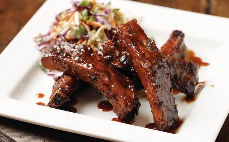 Root Beer Glazed Ribs · Five slow-roasted baby back pork ribs, BJ's Handcrafted Root Beer glaze, spicy sriracha slaw, green onions