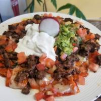 Chilaquile-Nachos · Chips covered in your choice salsa, beans, Monterrey Jack cheese, choice of meat, guacamole,...