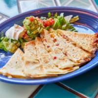Hector's Quesadilla · Grill a flour tortilla filled with cheese and mild green chiles, add a little sour cream and...