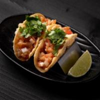 Salmon Poke Mini Tacos · JINYA's original salmon poke in a crispy wonton taco shell topped with cilantro.