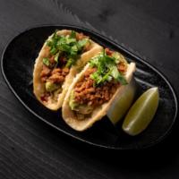 Impossible Mini Tacos · Plant-based tacos with Impossible Meat and guacamole on bite size crispy taco shells topped ...