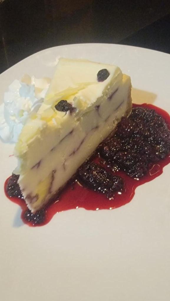 TOGO Blueberry Cobbler Cheesecake · white chocolate, whipped cream, warm berry compote