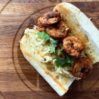 Blackened Shrimp Po'Boy · 6 medium blackened shrimp served on butter toasted New Orleans Gambinos French Bread atop a ...