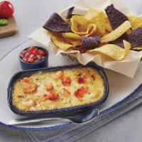 Langostino Lobster-artichoke-&-seafood Dip · Langostino and Maine lobster with spinach in a three-cheese blend. Served with yellow and bl...