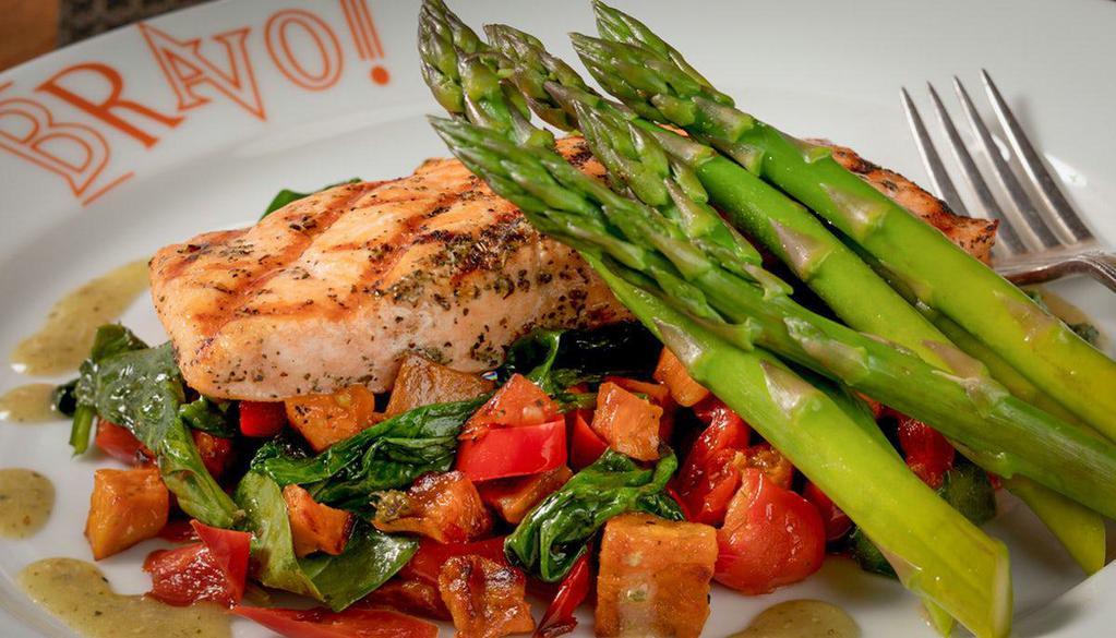 Grilled Salmon* · Fresh salmon, roasted peppers, grilled asparagus, tomatoes, spinach, sweet potatoes, pesto vinaigrette
