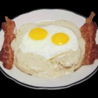 #9 Biscuits & Gravy · Biscuits with gravy, two eggs cooked to order and two pieces bacon or sausage.