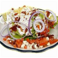 Wedge Salad · Quarter head of iceberg lettuce, tomato, red onion, chopped bacon and bleu cheese dressing a...