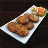 Fish Cake · Ground white fish, blended with curry paste, sliced green beans and deep-fried. Served with ...
