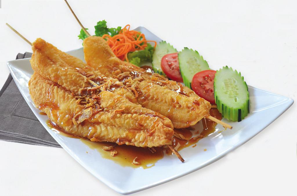 Tamarind Fish · Crispy fish fillet drizzled with sweet tamarind sauce sprinkled with roasted shallots.