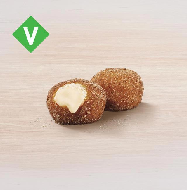Cinnabon Delights® 2 Pack · Warm donut holes filled with Cinnabon® signature cream cheese frosting, and dusted in Makara Cinnamon sugar