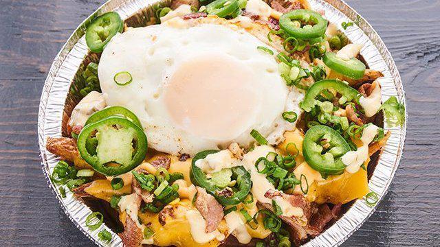 Loaded Kitchen Sink Fries · Cheese fries, roasted pulled pork, applewood smoked bacon, runny egg, scallions and jalapenos with house sauce and spicy mayo sauce.