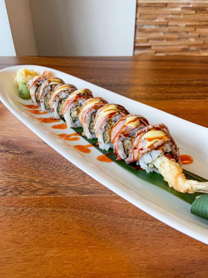 46. Surf and Turf Roll · Shrimp tempura, cucumber topped with NY strip, creamy wasabi, spicy sauce. Cooked.