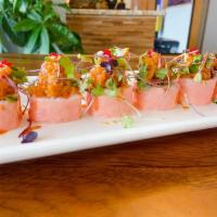 51. Sweet Heart Roll · Salmon and avocado, pink soy wrap, topped spicy tuna, micro green, tobiko.