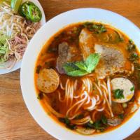 122. Bun Bo Hue with Beef and Pork Broth · Spicy beef noodle soup with pork hock, Vietnamese ham, well-done flank Hue style.
