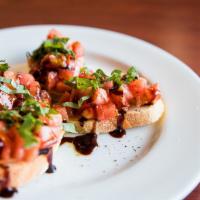 Bruschetta · Homemade bread topped with fresh tomatoes, gorgonzola cheese, basil, and extra virgin olive ...