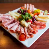 Antipasto Casareccio · A gourmet plate of an assortment of Italian cheese, cold cuts, olives, and more.