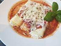 Manicotti Dinner · Pasta tubes stuffed with a rich blend of ricotta, mozzarella, and Parmesan cheeses on a bed ...