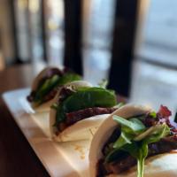 Pork Belly Sliders · Pork belly braised in a soy, garlic and ginger sauce, served on a fried or steamed bun.
