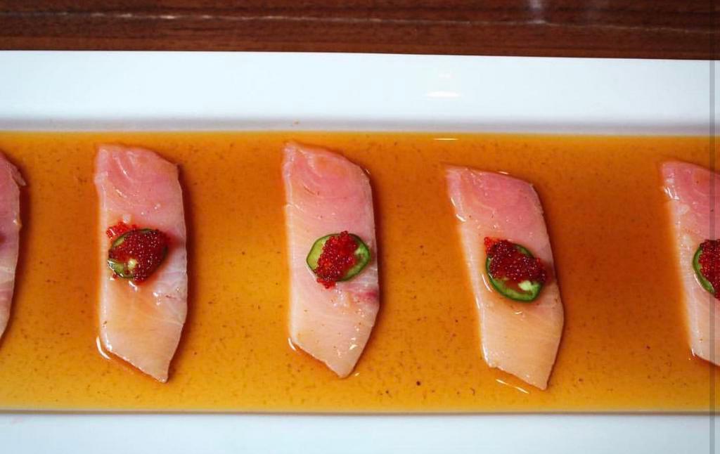Yellowtail Ceviche · Thinly sliced yellow tail sashimi in jalapeno ponzu sauce, topped with red tobiko and jalapeno.