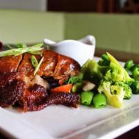 Crispy Duck · Crispy roasted duck with stir fried vegetables. Served with sweet and sour sauce on the side.