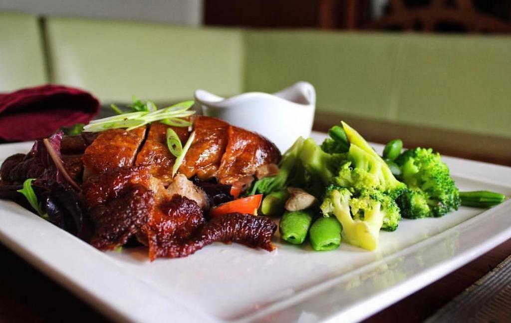 Crispy Duck · Crispy roasted duck with stir fried vegetables. Served with sweet and sour sauce on the side.