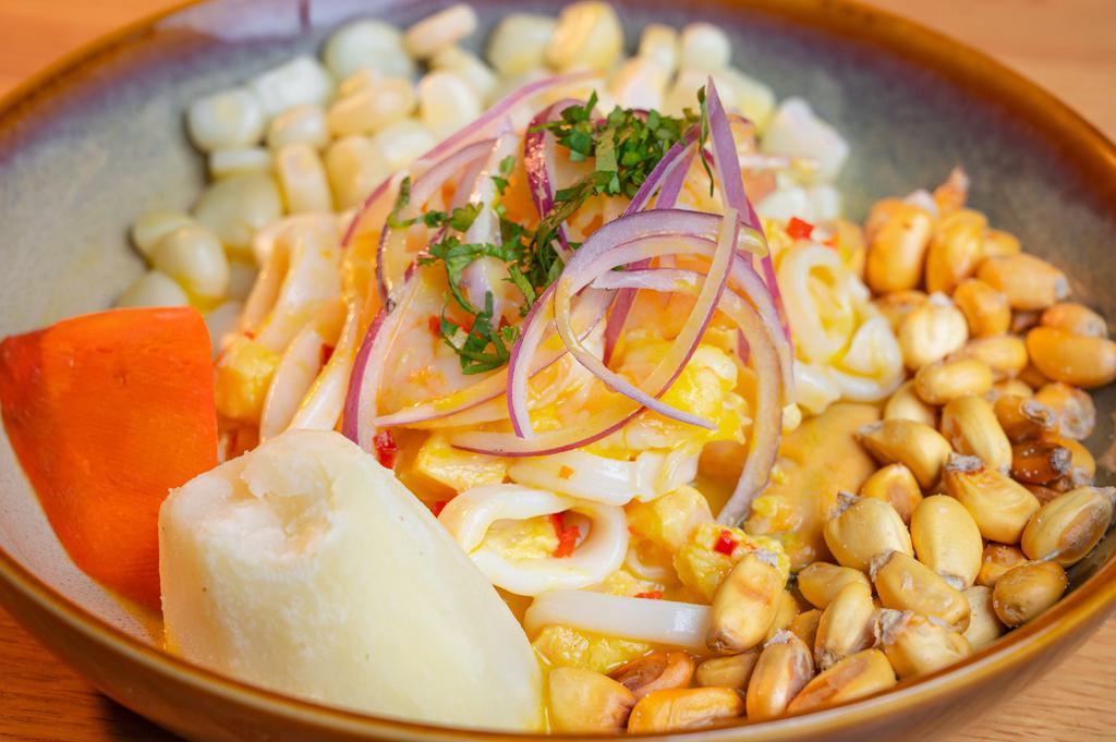 CEVICHE MIXTO · MARINATED FRESH & LOCAL FLUKE, CALAMARI, SHRIMP & MUSSLES AJI AMARILLO LECHE DE TIGRE, ACCOMPANIED BY SWEET POTATO, BAKED POTATO AND PERUVIAN CORN. 