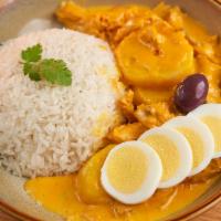 AJI DE GALLINA · Shredded chicken with yellow chilli pepper sauce served with white rice, potatoes & boiled e...