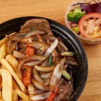 BISTEC ENCEBOLLADO · 8oz Grilled steak with sautéed onions and tomatoes.