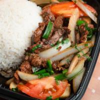 LOMO SALTADO · Peruvian Stir-Fried Sautéed beef, tomatoes and onions, served with fries & white rice.