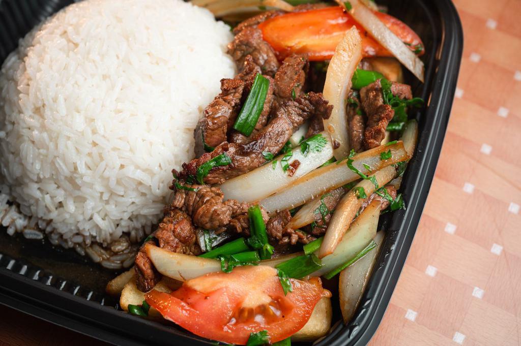 LOMO SALTADO · Peruvian Stir-Fried Sautéed beef, tomatoes and onions, served with fries & white rice.