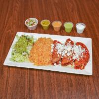 Enchiladas · 3 pieces. Hand-rolled corn tortillas filled with chicken with red sauce on top served with r...