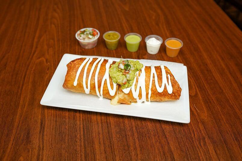 Chicken Chimichanga · Flour tortilla filled with rice, refried beans, your choice of meat, and mozzarella cheese then deep-fried.