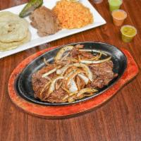 Arrachera Platter · Mexican style marinated grilled steak. Served with rice, refried beans, tortillas, and a pin...