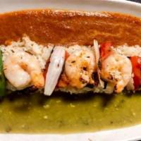 Alambre de Camarones · Marinated jumbo shrimp skewered and grilled with tomatoes, onions and serrano chiles, over r...