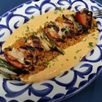 Alambre de Pollo · Marinated chicken skewered and grilled with peppers, onions and pasilla de Oaxaca cream sauc...
