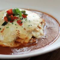 Budin de Pollo · Gluten-Free. Braised chicken tinga layered with soft corn tortillas, Chihuahua cheese, roast...