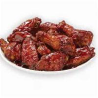 Smoky BBQ Bone-In Wings · Our traditional bone-in wings oven roasted, and then tossed in smoky BBQ sauce. An amazing c...