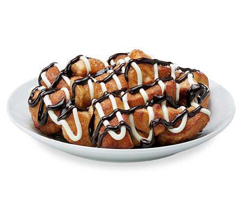 Chocolate and Cream Monkey Bread · Bite-sized pieces of freshly made dough, sprinkled with cinnamon and sugar, then baked and drenched in cream cheese and chocolate icing.