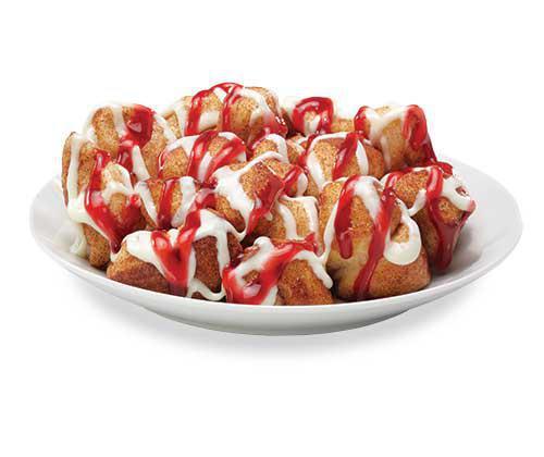 Raspberry Cheesecake Monkey Bread · Bite-sized pieces of freshly made dough, sprinkled with cinnamon and sugar, then baked and drenched in cream cheese icing and raspberry topping.