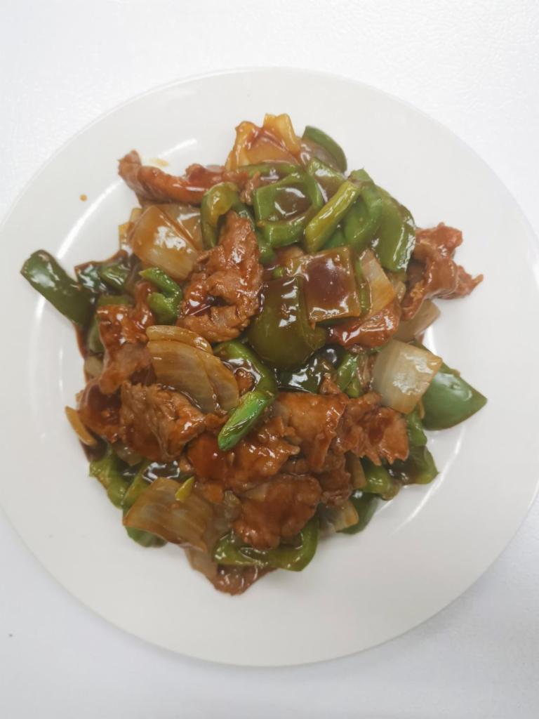 85. Pepper Steak with onion · Served with white rice.