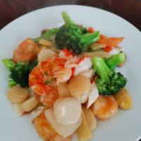 S1. Seafood Delight · Lobster, jump shrimps, scallops, and crab meat with vegetables sauteed in a white wine sauce...