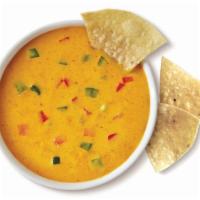 Queso (8oz)  and Chips · 8 oz of spicy three pepper cheese dip. Served warm with freshly made tortilla chips.